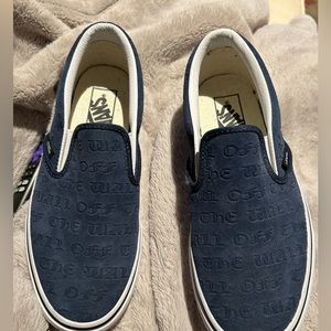 Blue Textured vans that say “Off the wall”